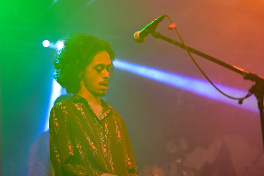 Crimson Roots keyboard player performing under stage lights